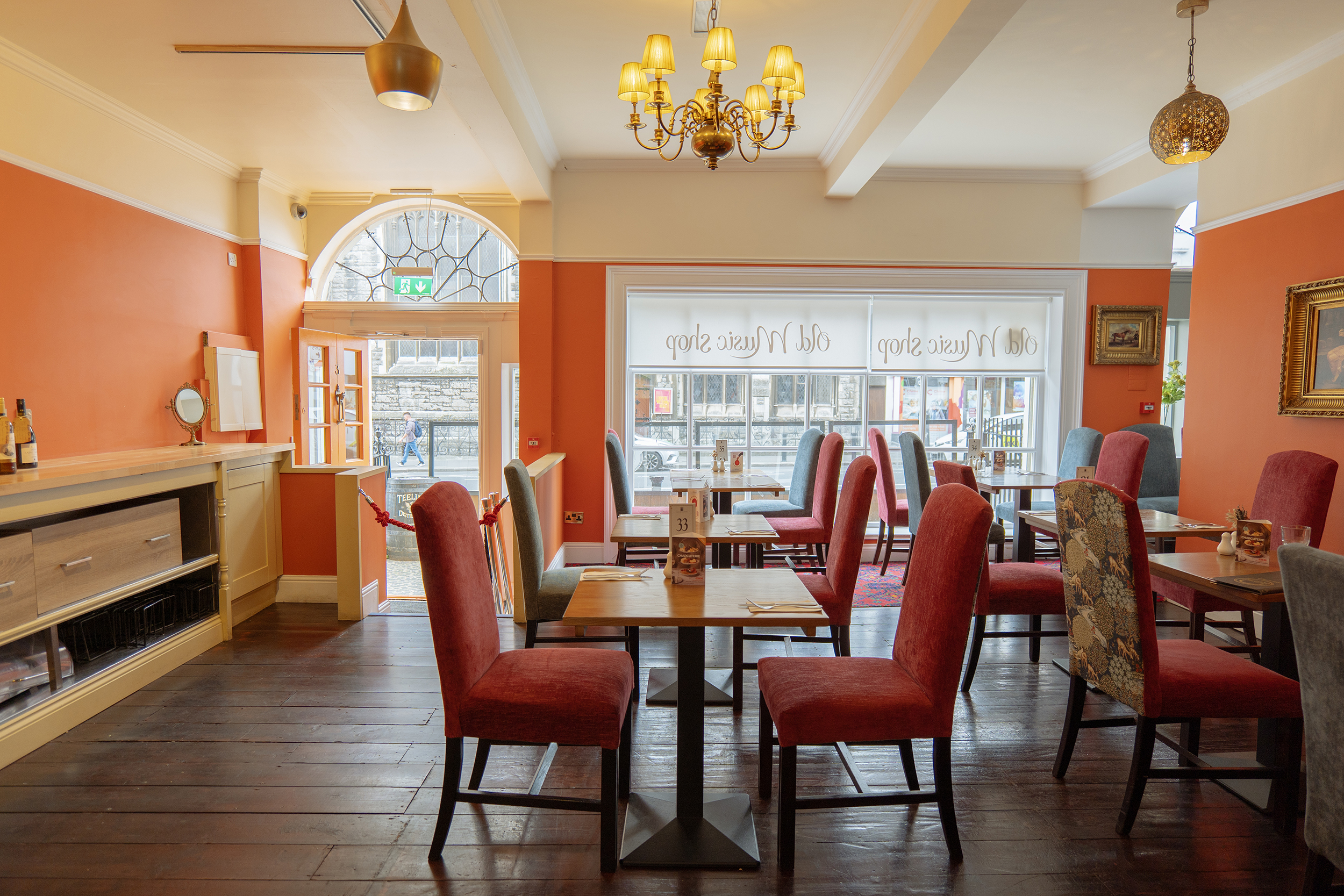 Georgian orange painted elegant room in Old Music Shop restaurant. Table and chairs